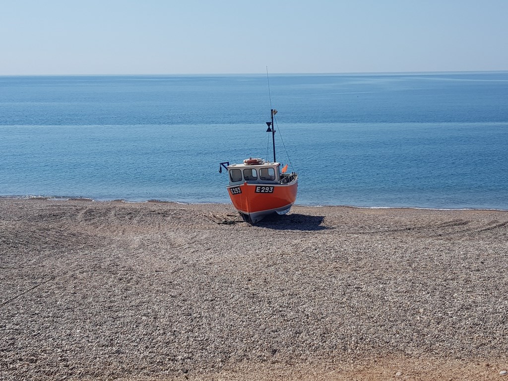 A Lone Fishing Boat On Branscombe Beach